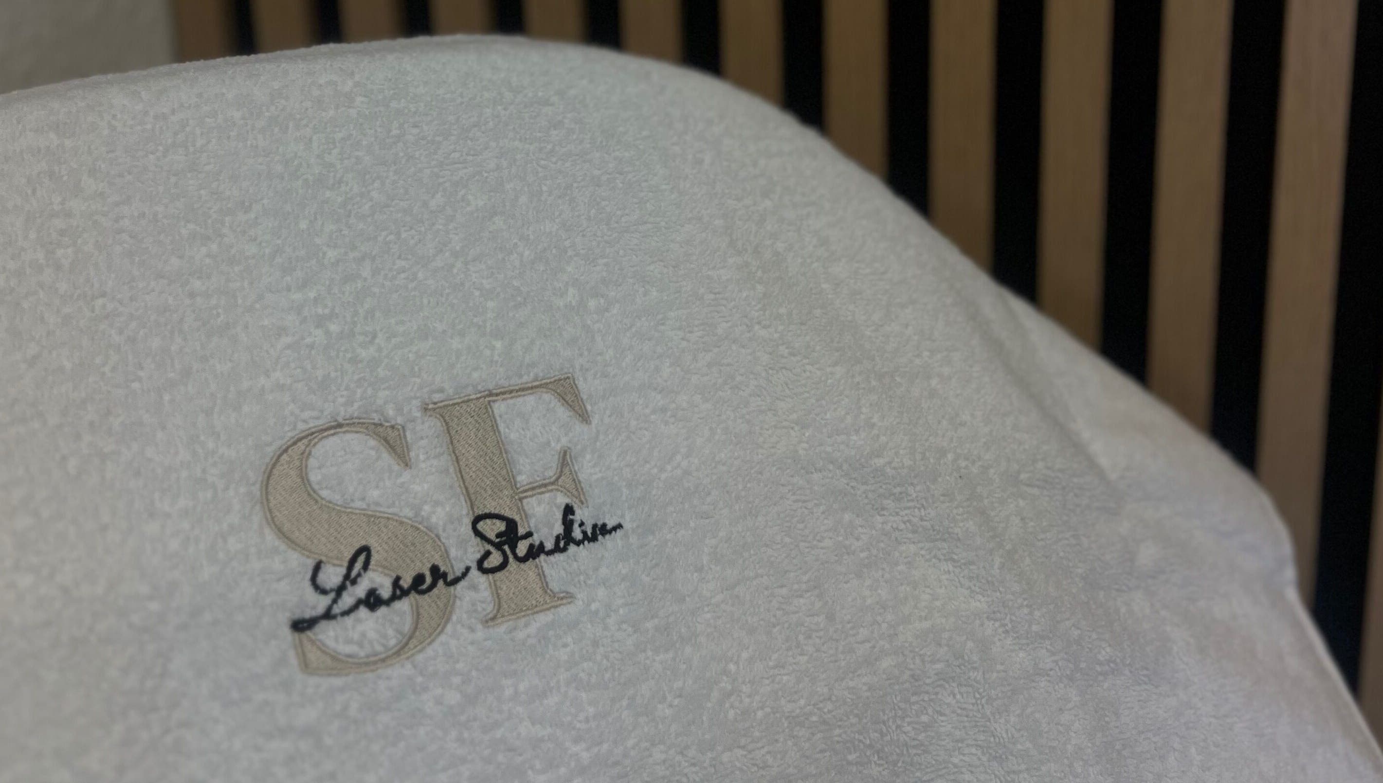 Embroidered SF Laser Studio towel at Dereham, England, GB highlighting luxury spa service.