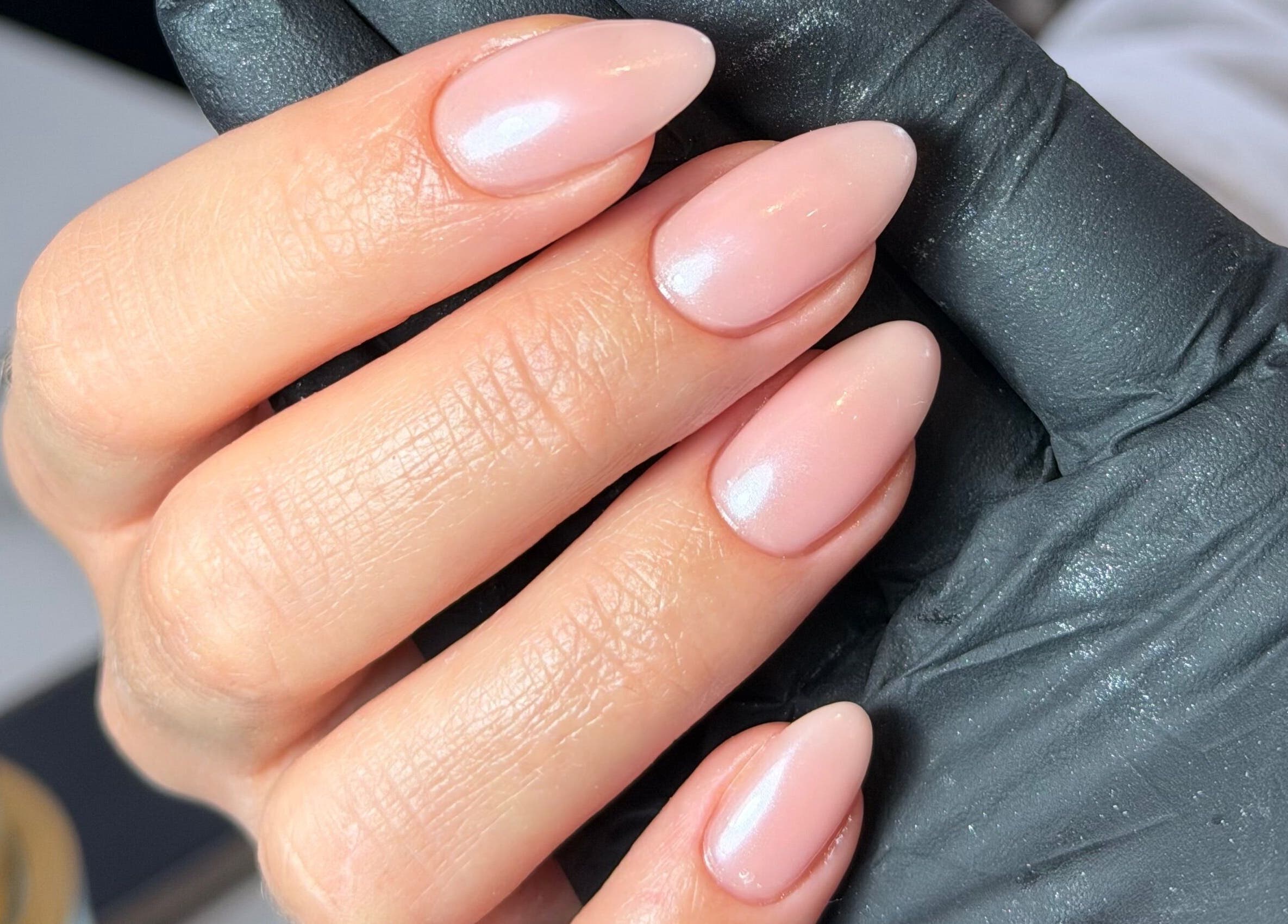 Close-up of sleek pink manicure at SF Laser Studio, Dereham, England, GB, showcasing elegant nail art.