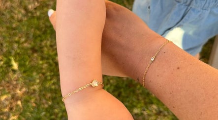 Two hands with gold bracelets at Indie Bookworm Event, Melbourne, Victoria, AU.