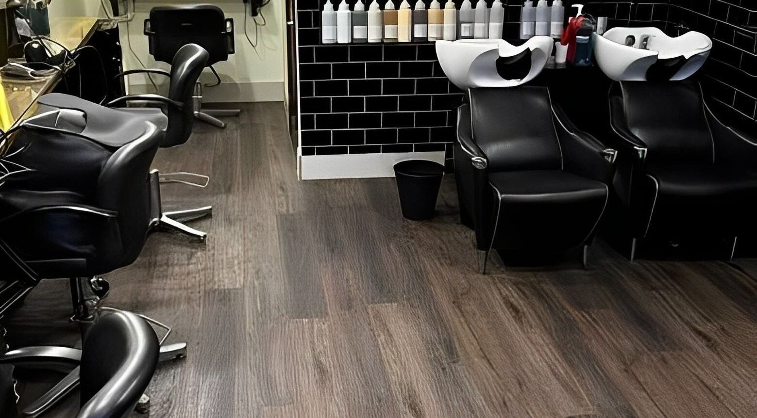 Sleek interior of The Green Hairdressing Salon in Long Eaton, England, GB, featuring modern styling chairs.