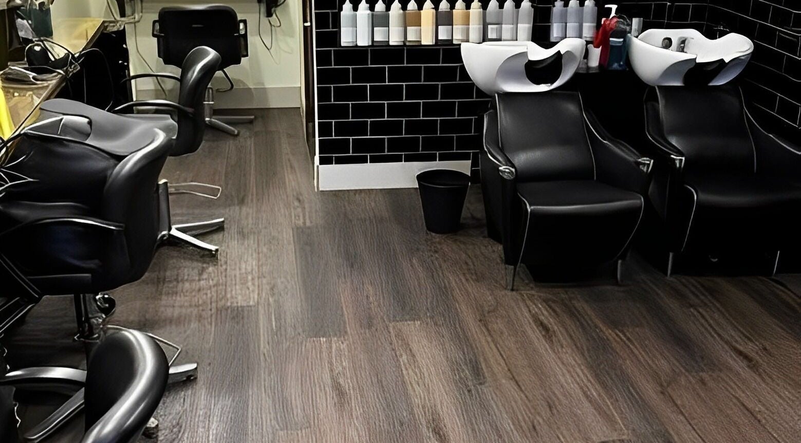Sleek interior of The Green Hairdressing Salon in Long Eaton, England, GB, featuring modern styling chairs.