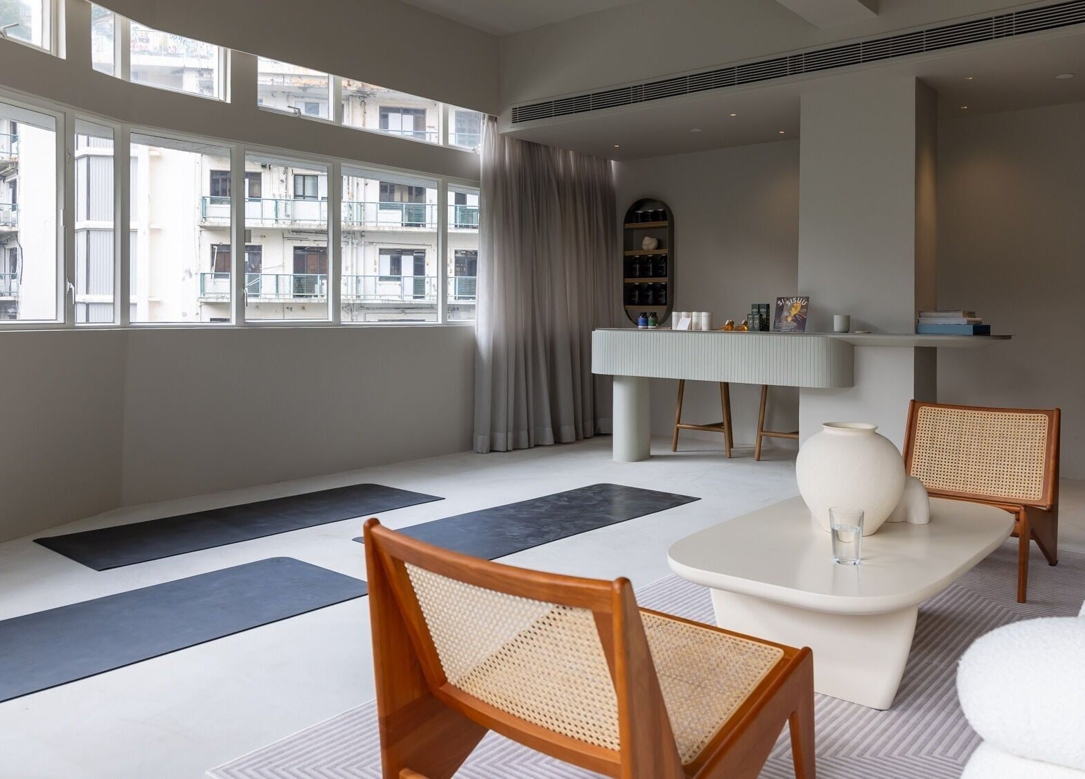 Peaceful yoga space at ACME Wellness Hong Kong on Hong Kong Island, HK with mats and soft seating.