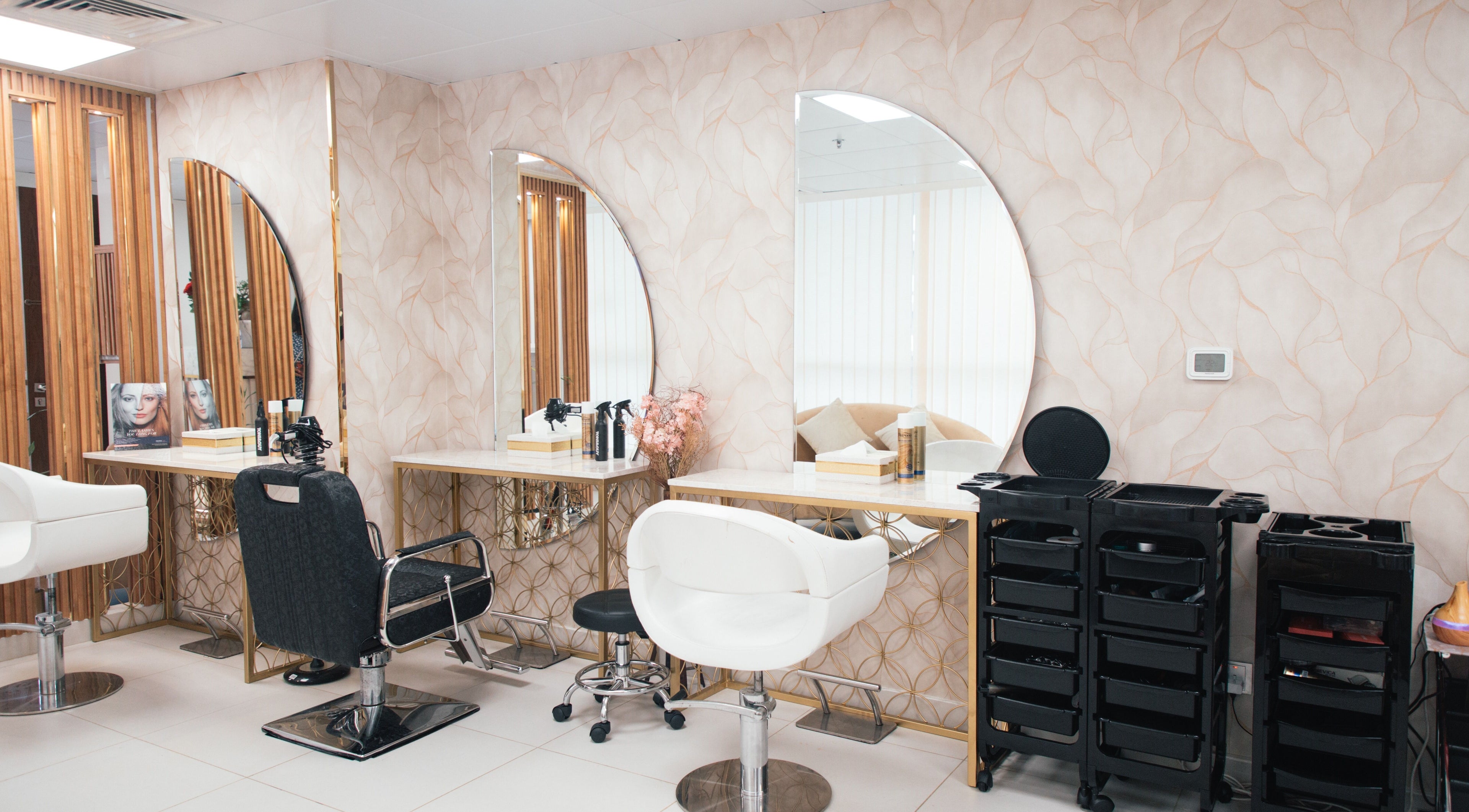Chic styling stations with large mirrors at Curly Sue Beauty Lounge, Abu Dhabi, Abu Dhabi, AE.