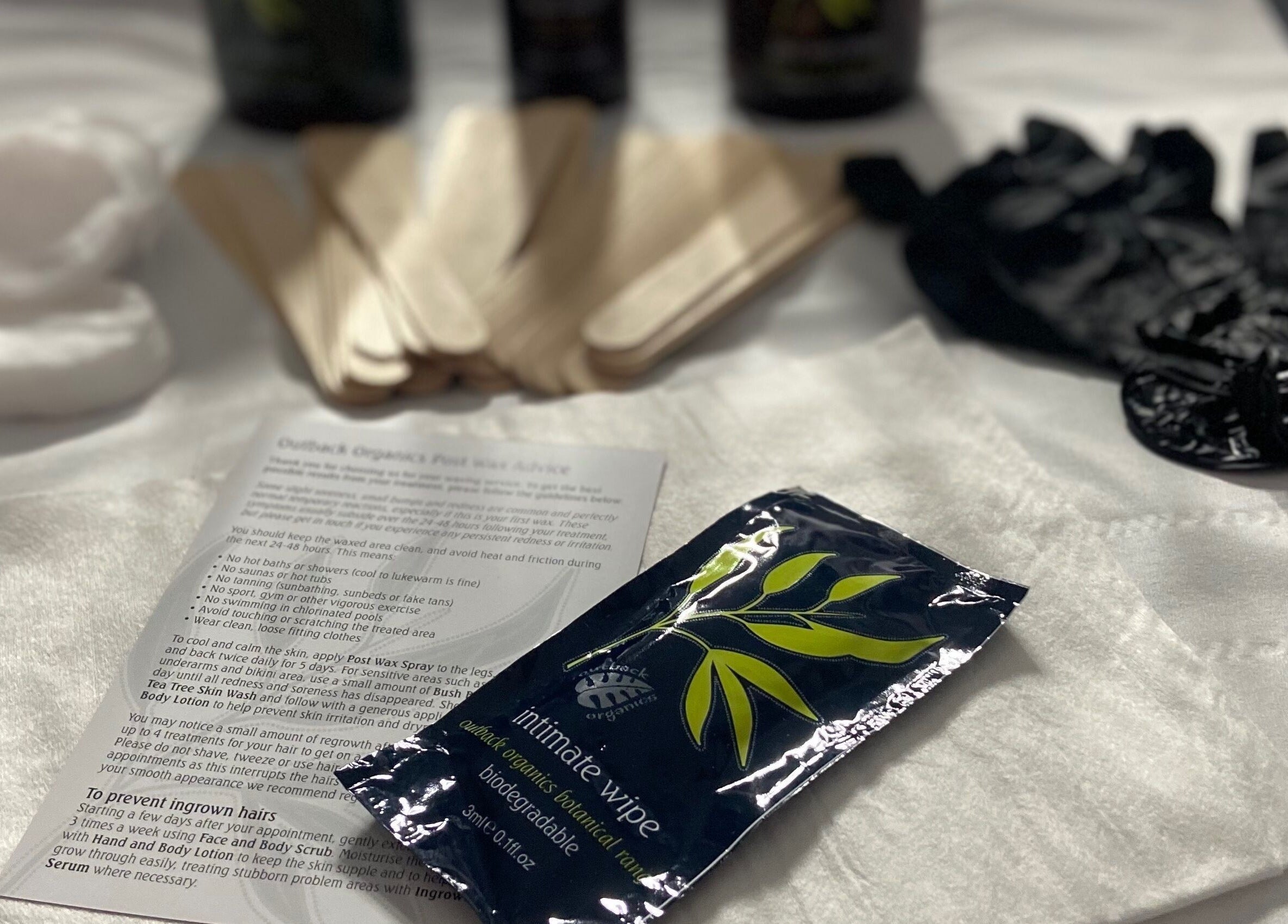 Waxing prep tools at Simply Wax, Ballyclare, Northern Ireland, GB, showcasing cotton, sticks, and gloves.