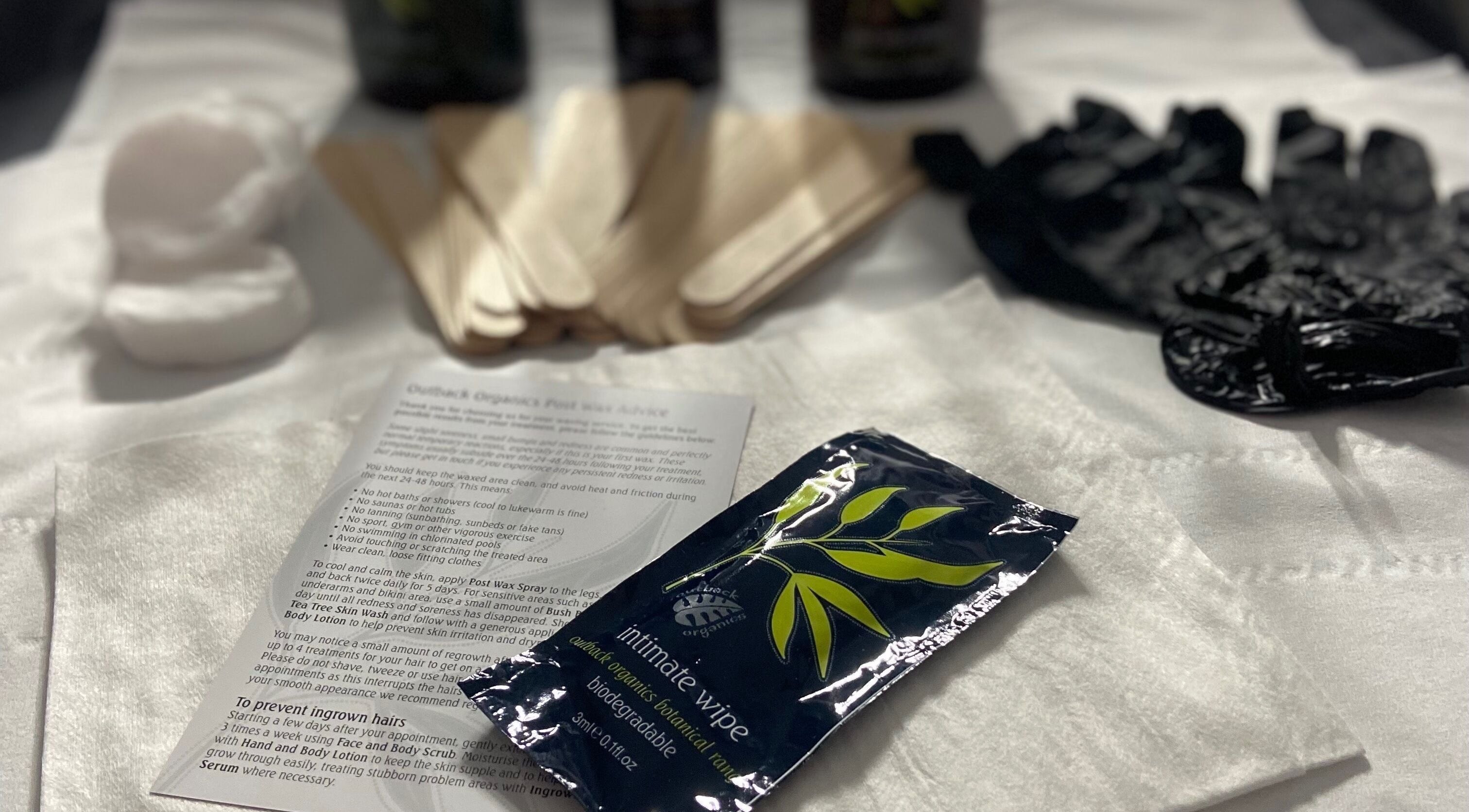 Waxing prep tools at Simply Wax, Ballyclare, Northern Ireland, GB, showcasing cotton, sticks, and gloves.