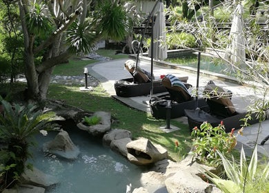 Relax by the serene pool at Sembunyi Spa, Cyberjaya, Selangor, MY amidst lush greenery and natural beauty.