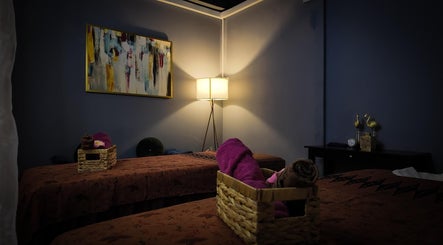 Cozy treatment room at Qasandra Spa Retreat in Petaling Jaya, Selangor, MY, featuring warm lighting and elegant decor.