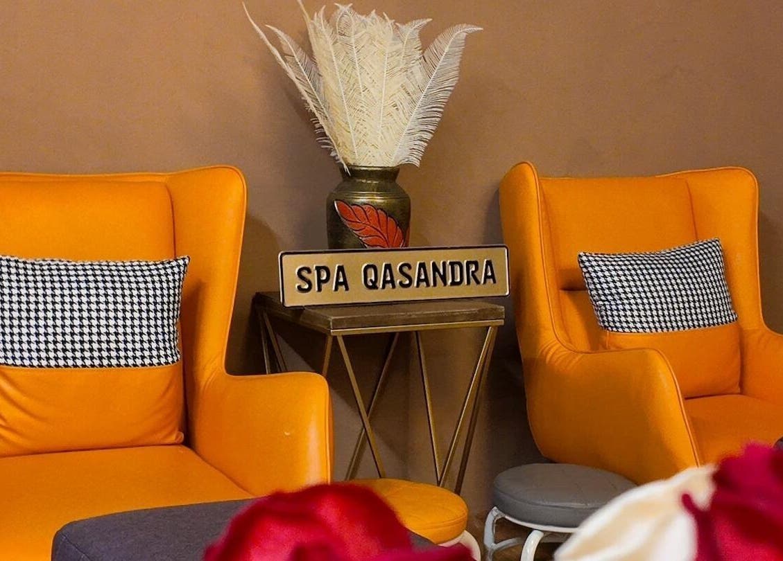 Two vibrant orange chairs at Qasandra Spa Retreat in Petaling Jaya, Selangor, MY, creating a warm ambience.
