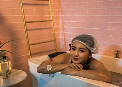 Woman enjoys a relaxing bath at Qasandra Spa Retreat in Petaling Jaya, Selangor, MY.