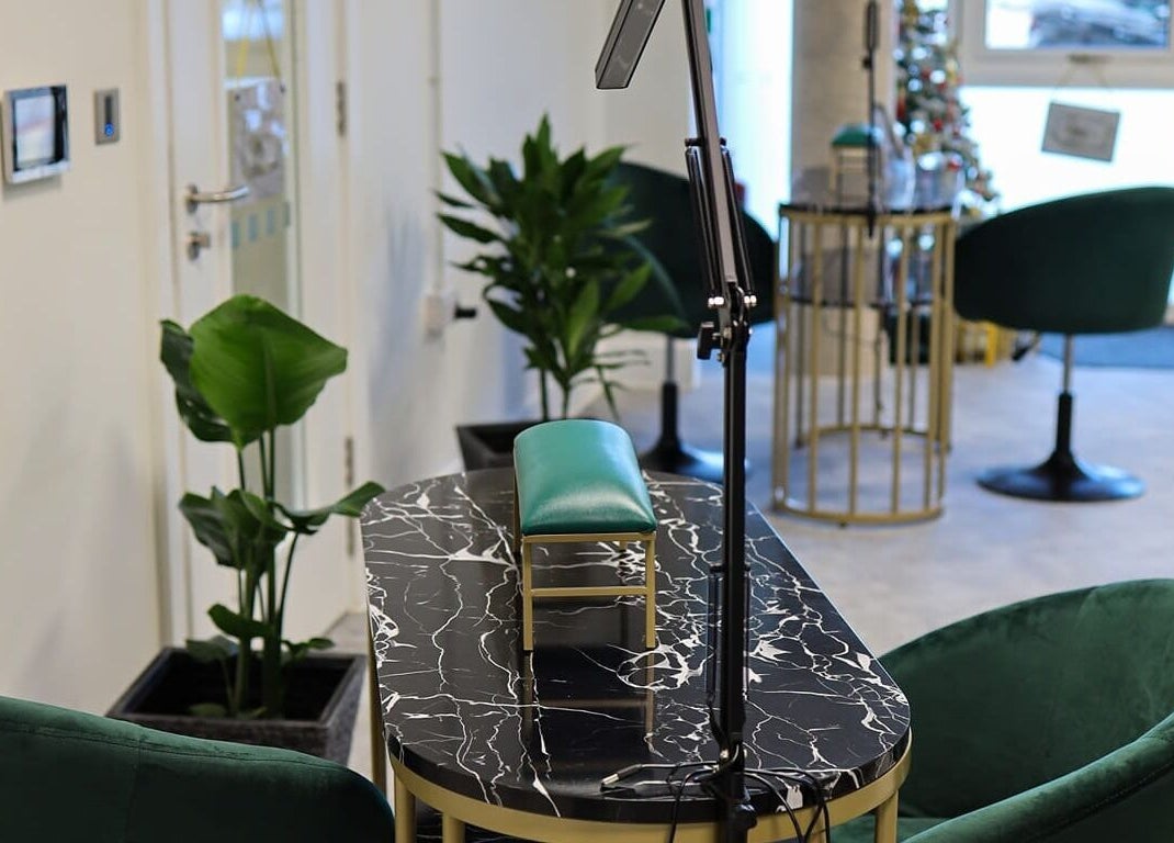 Sophisticated nail station at Maketimeforyou, Houghton Regis, England, GB with modern decor and green chairs.
