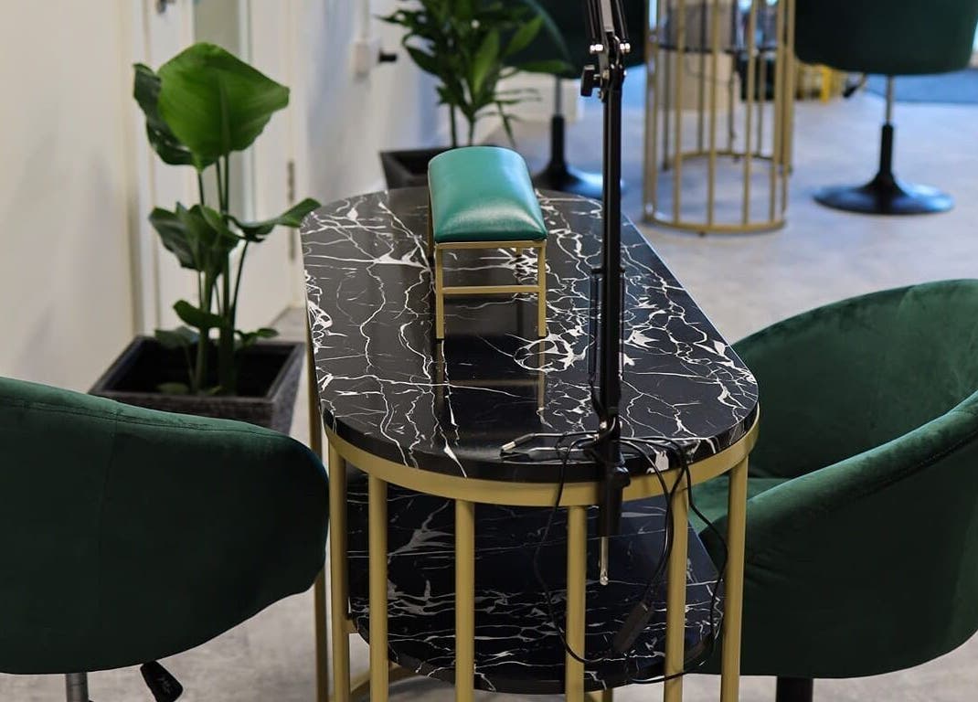 Stylish nail station at Maketimeforyou, Houghton Regis, England, GB with marble top and green chairs.
