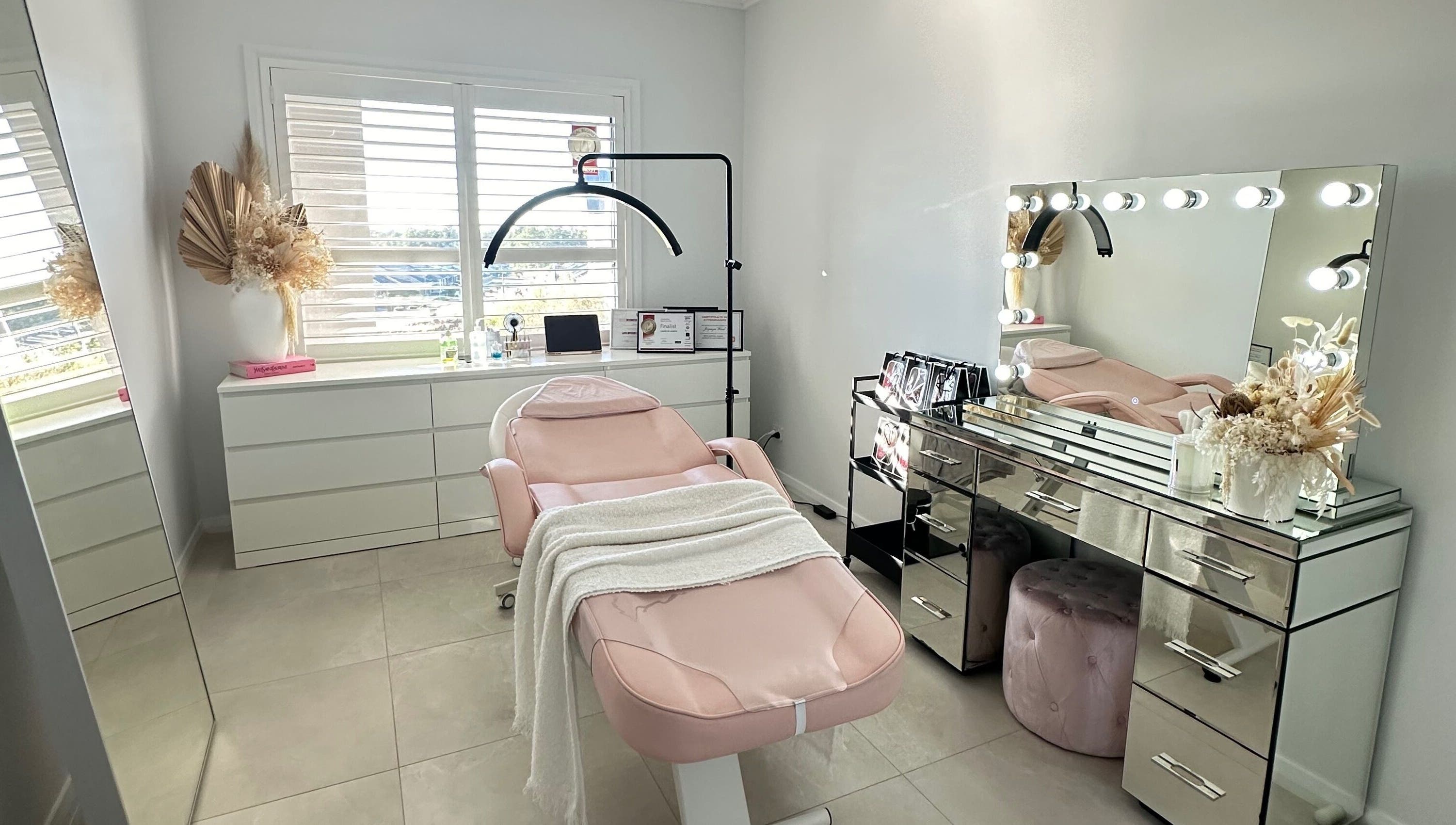 Chic beauty room at Lashes By Jazmyn, Silverdale, New South Wales, AU with a plush pink chair and vanity mirror lights.