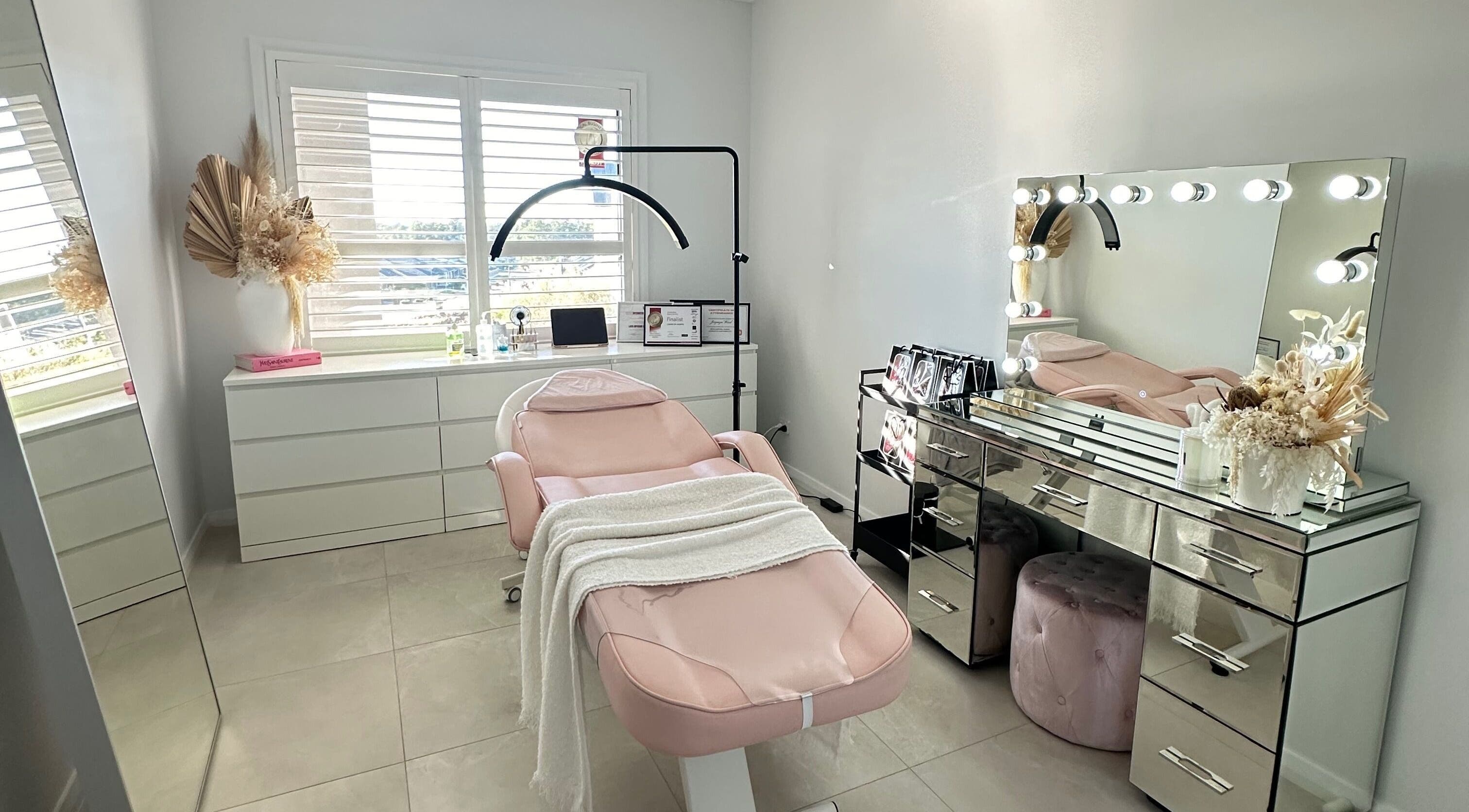 Chic beauty room at Lashes By Jazmyn, Silverdale, New South Wales, AU with a plush pink chair and vanity mirror lights.