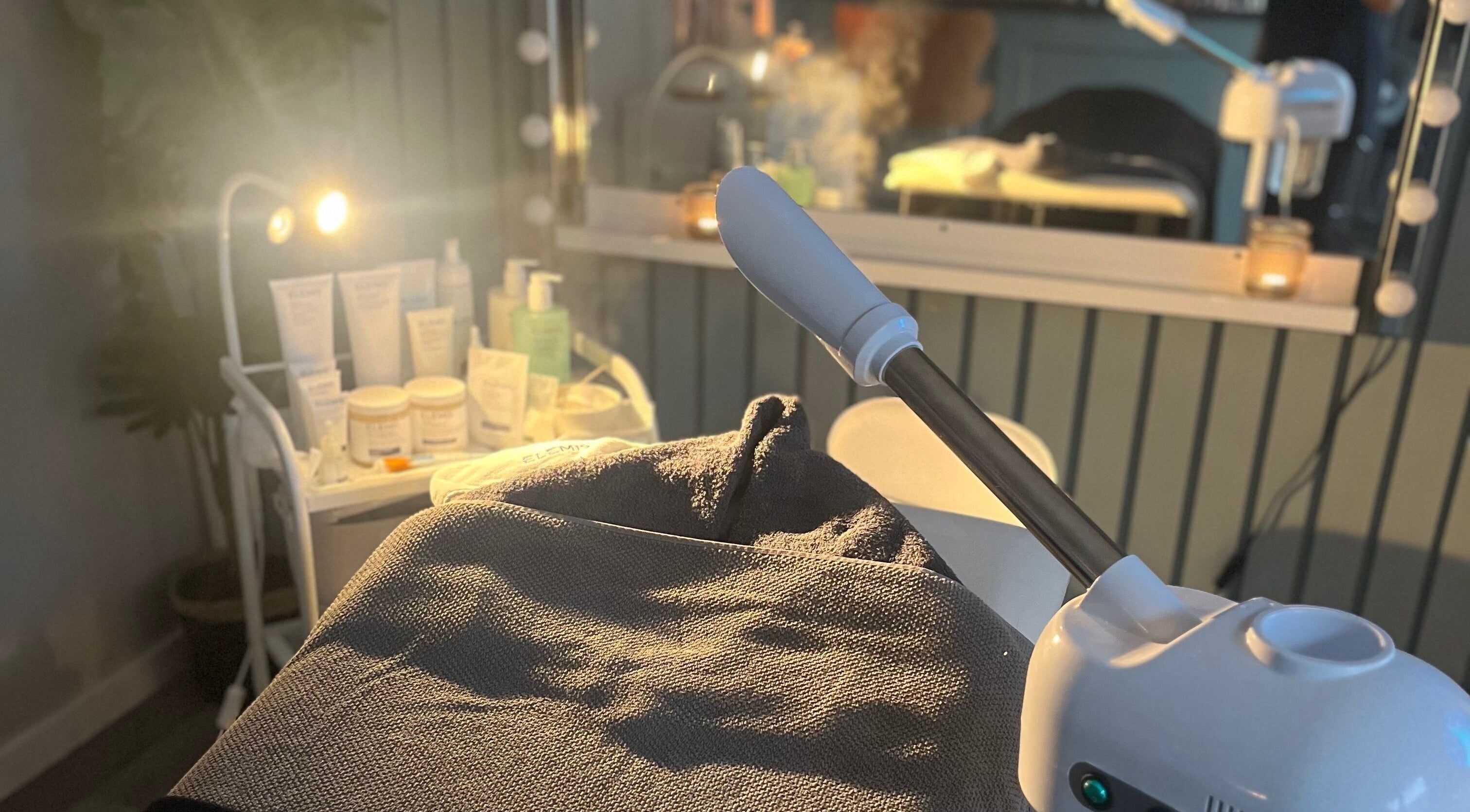 Cozy treatment room at Beauty Bar, Celbridge, County Kildare, IE with skincare products and a steam machine.
