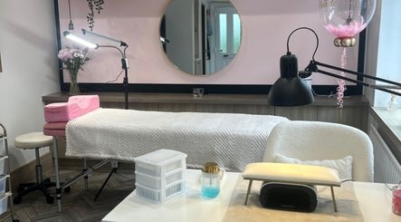 Serene beauty room at House of Beauté in Ibstock, England, GB, featuring a plush treatment bed and soft lighting.