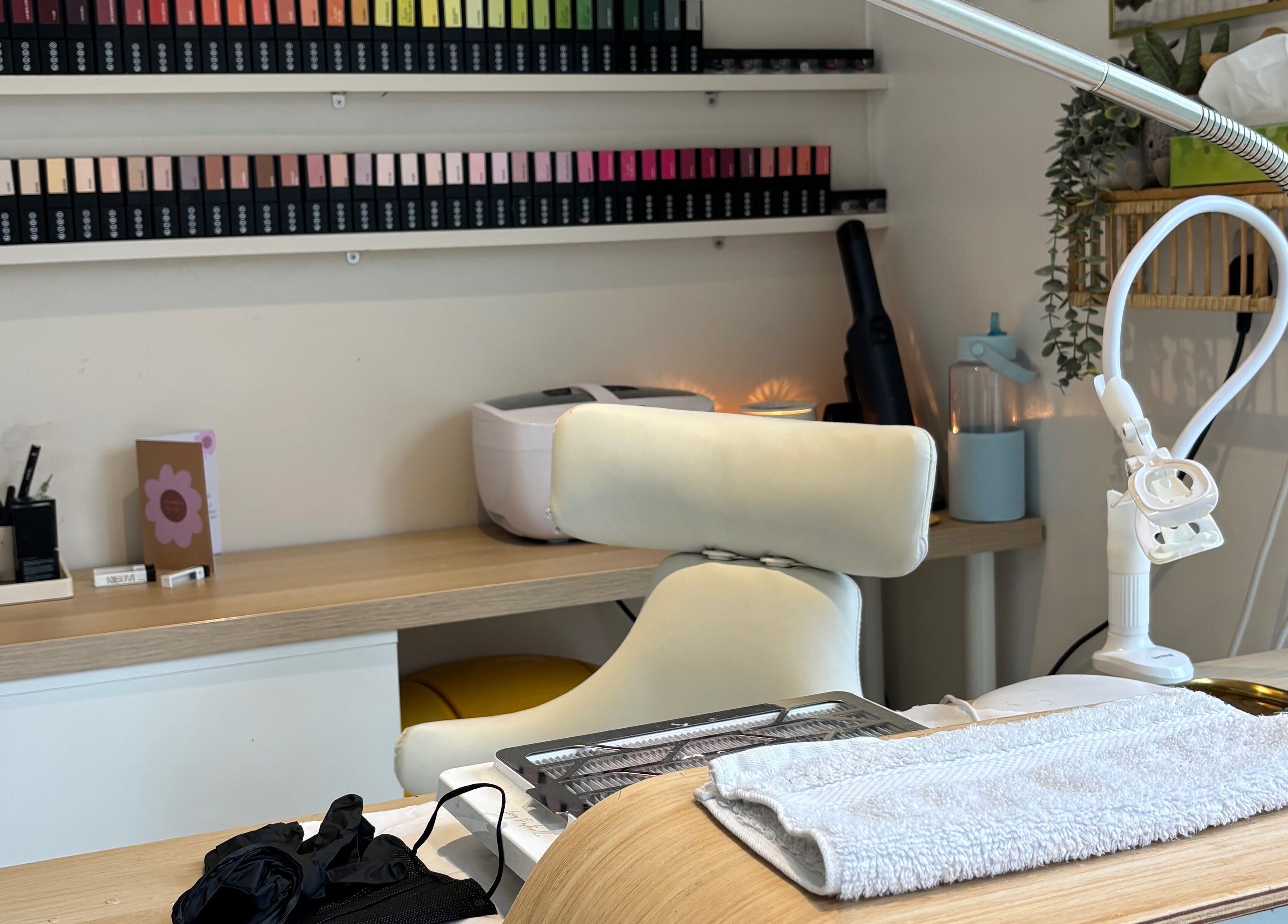 Nail care station at Indz Inc, Altrincham, England, GB, showcasing manicure tools and vibrant nail polish collection.