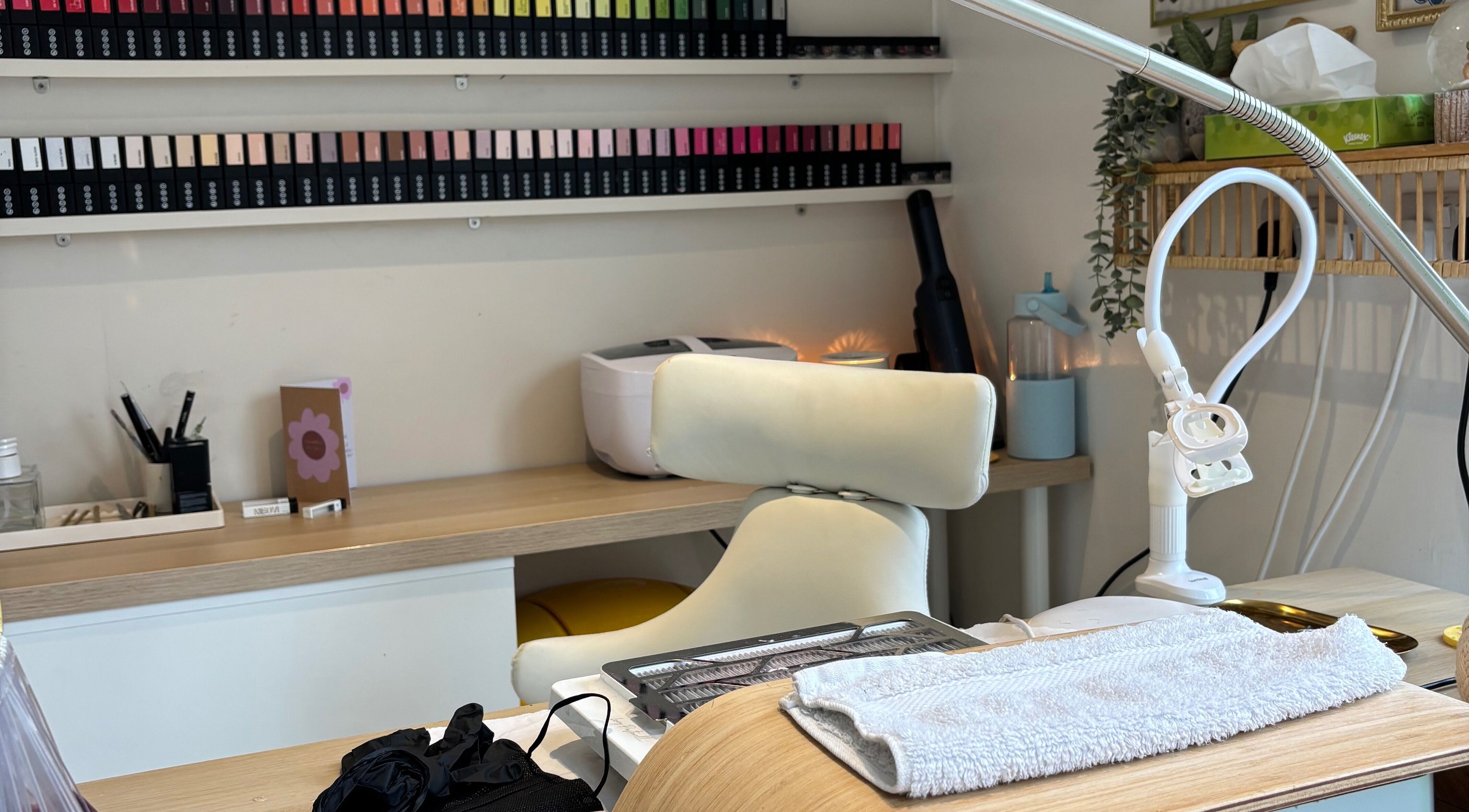 Nail care station at Indz Inc, Altrincham, England, GB, showcasing manicure tools and vibrant nail polish collection.