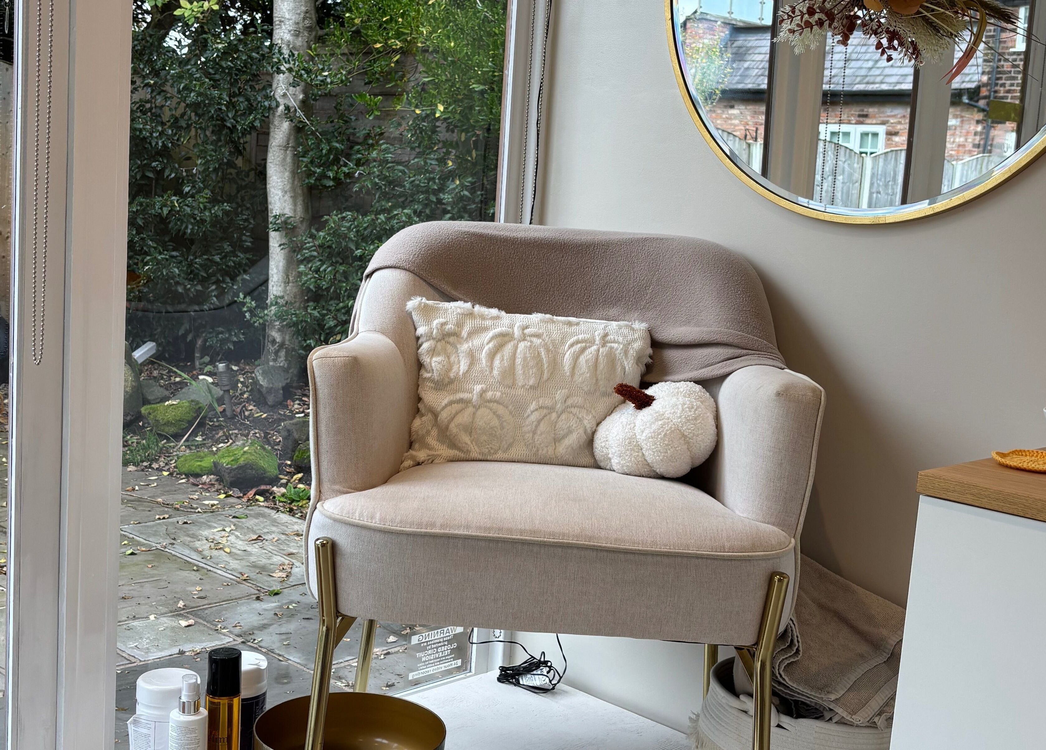 Cozy armchair at Indz Inc, Altrincham, England, GB, perfect for relaxation in a serene outdoor setting.