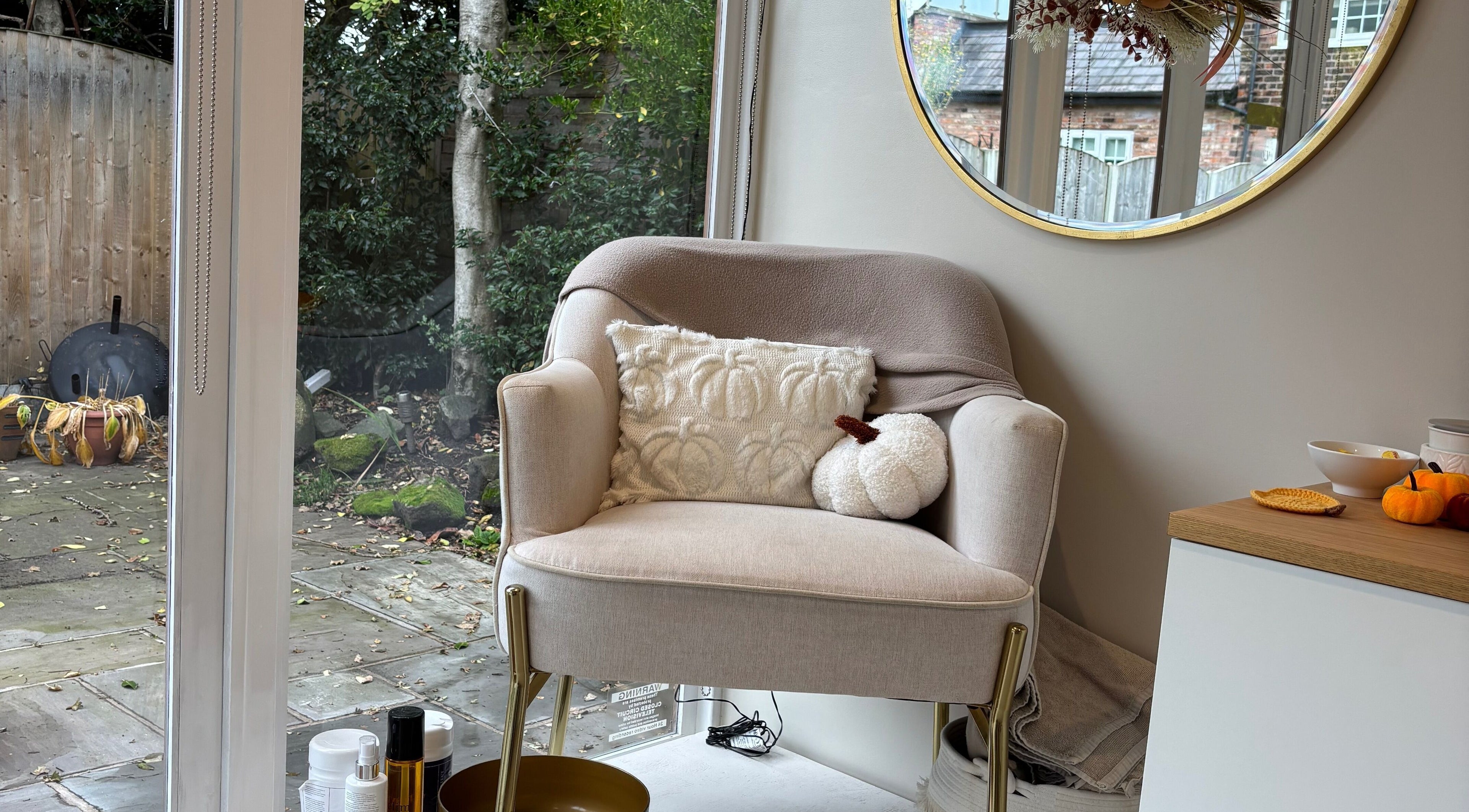 Cozy armchair at Indz Inc, Altrincham, England, GB, perfect for relaxation in a serene outdoor setting.