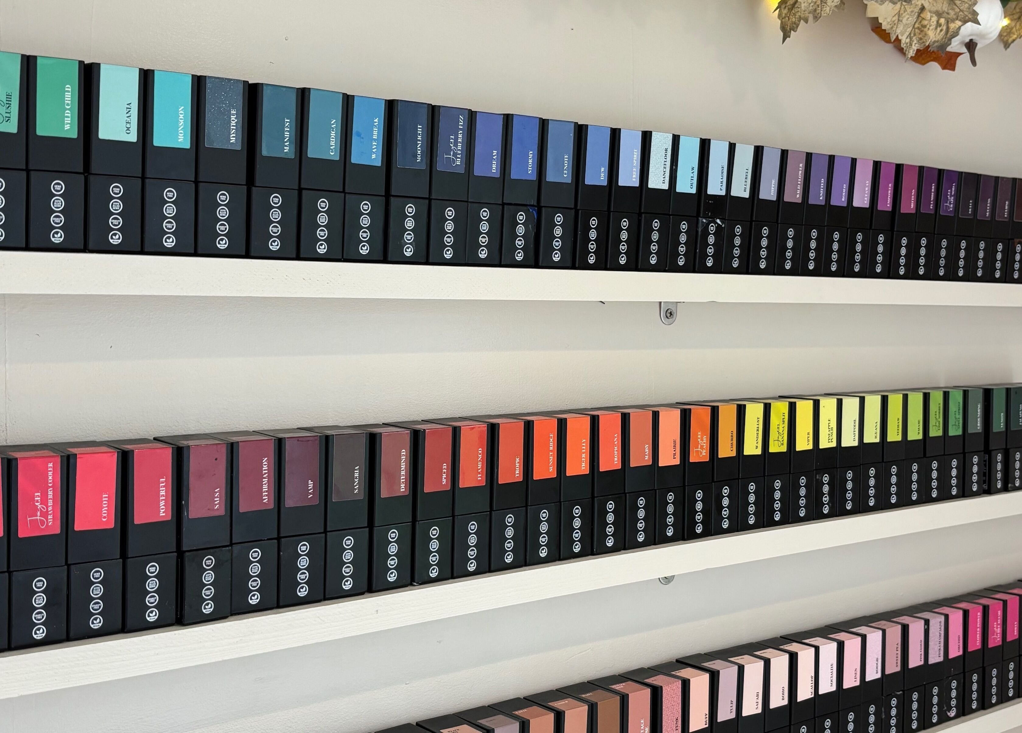 Vibrantly colored product display at Indz Inc, Altrincham, England, GB showcasing a rainbow of beauty supplies.