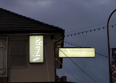 Illuminated Visage Clinics Merrylands sign at night in Merrylands, New South Wales, AU, highlighting clinic location.