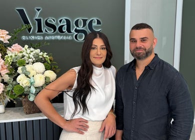 Two welcoming staff at Visage Clinics Australia | Belmore, floral decor in Belmore, New South Wales, AU.