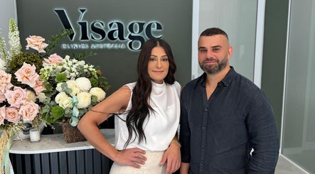 Two welcoming staff at Visage Clinics Australia | Belmore, floral decor in Belmore, New South Wales, AU.