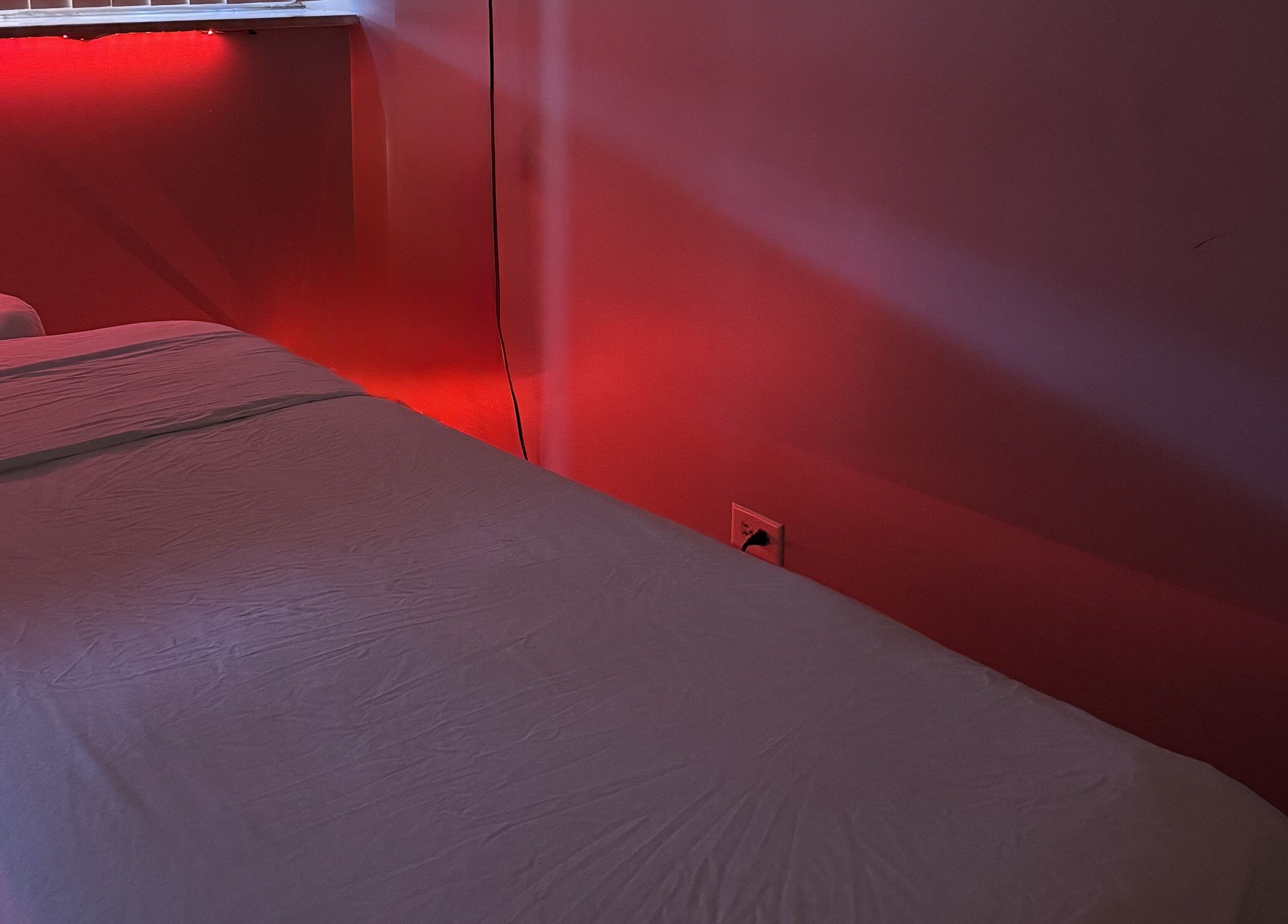 Tranquil massage room with red lighting at Wellness in Harmony Massage & Sound, Des Plaines, Illinois, US.