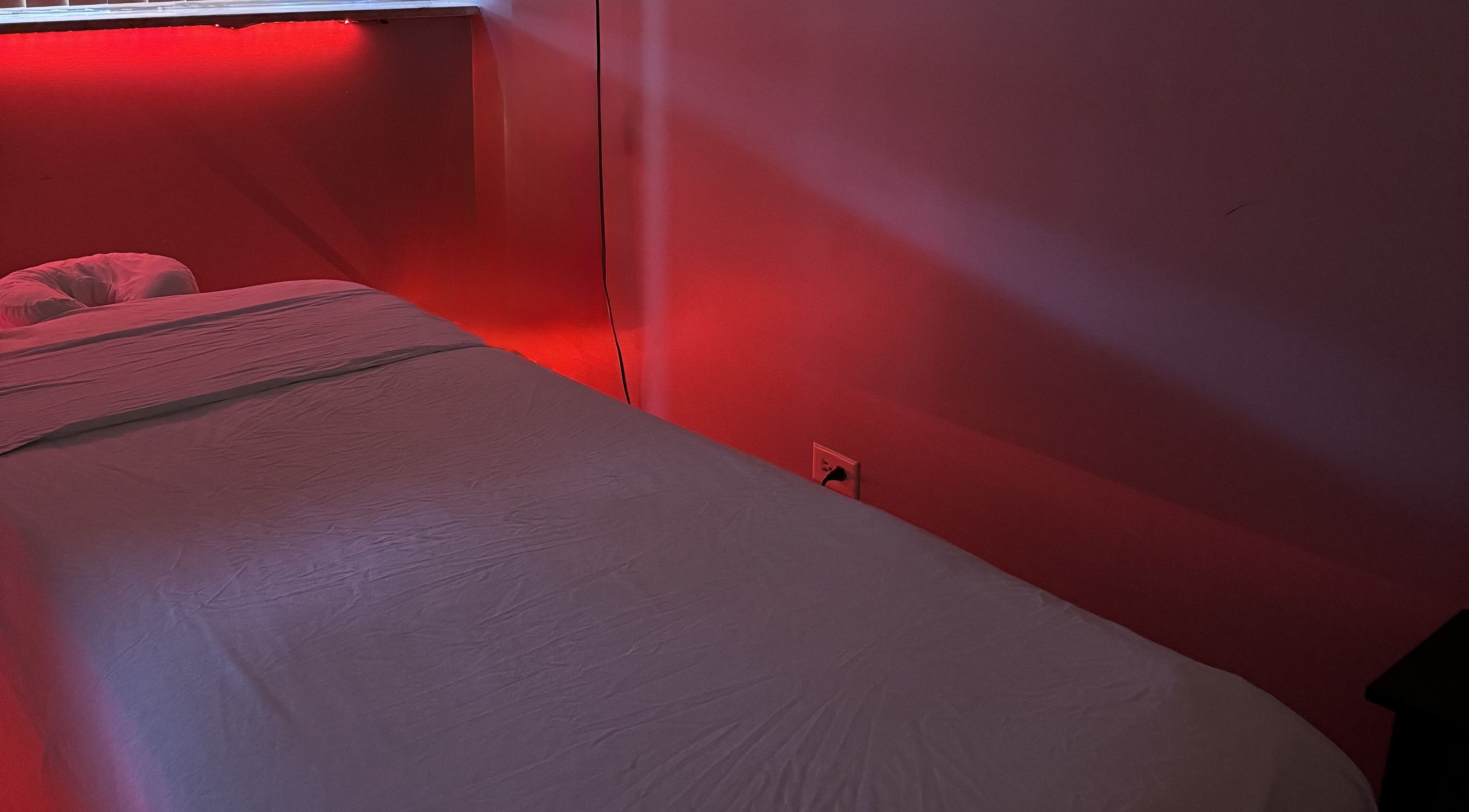 Tranquil massage room with red lighting at Wellness in Harmony Massage & Sound, Des Plaines, Illinois, US.