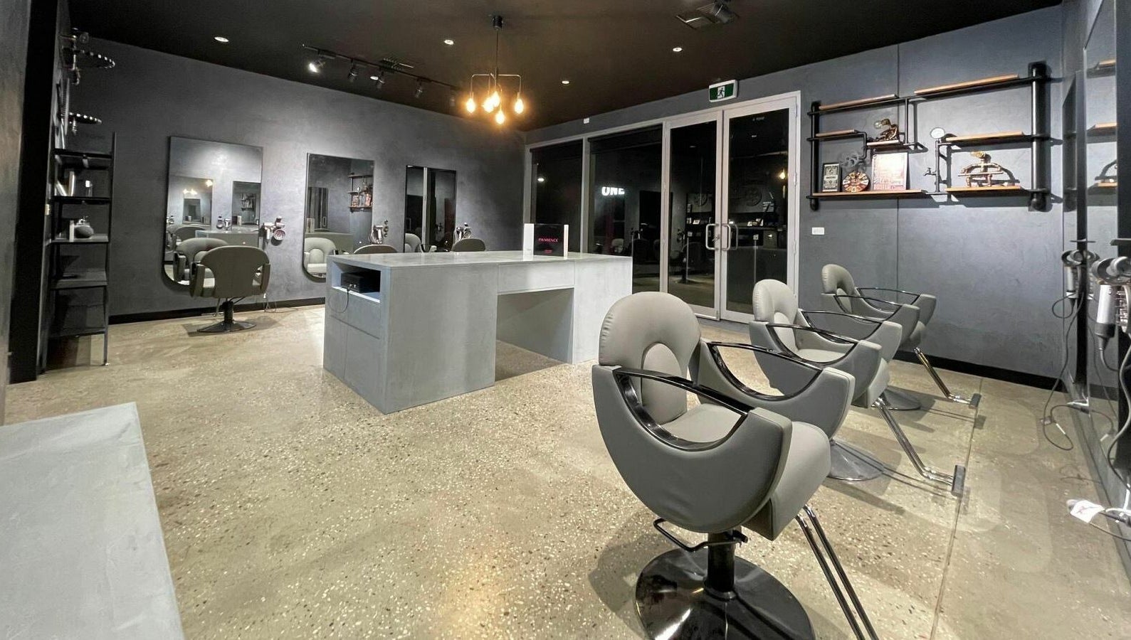 Modern salon interior at The One Fashion Hair in Melbourne, Victoria, AU with sleek chairs and mirrors.