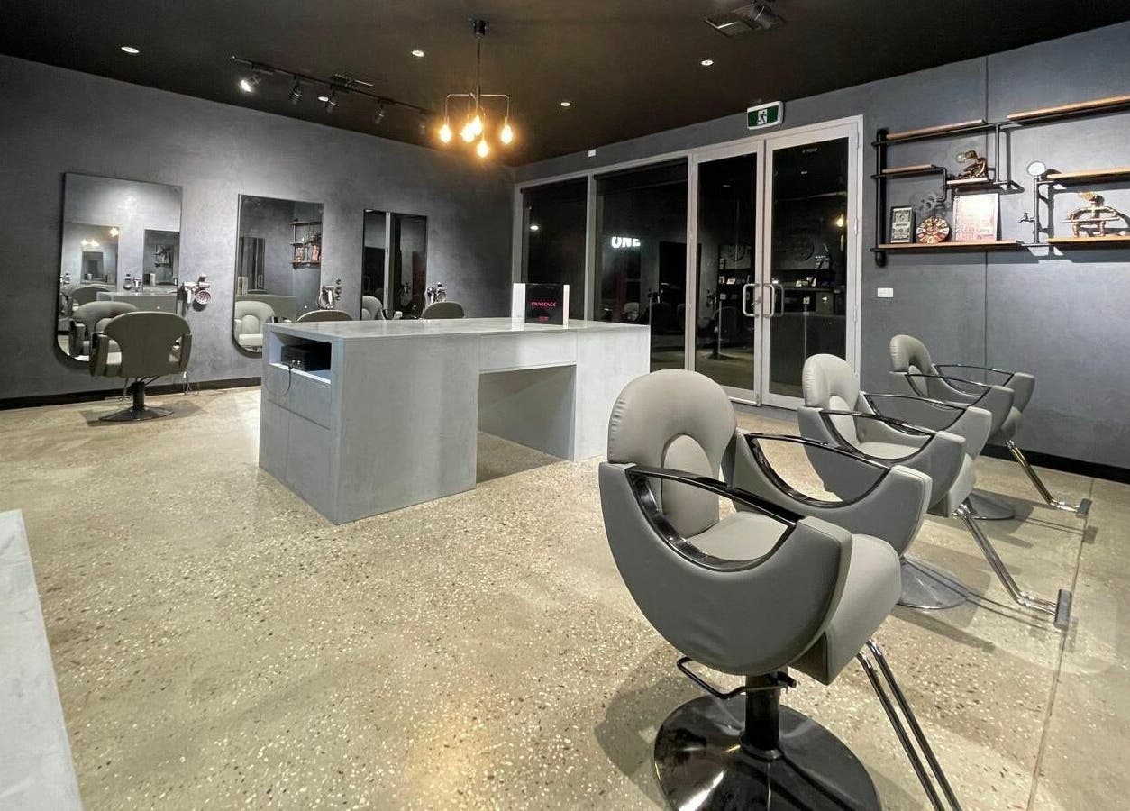 Modern salon interior at The One Fashion Hair in Melbourne, Victoria, AU with sleek chairs and mirrors.