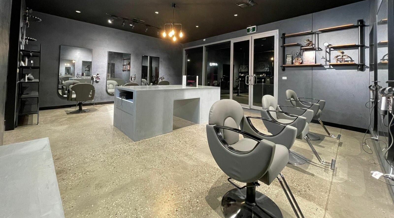 Modern salon interior at The One Fashion Hair in Melbourne, Victoria, AU with sleek chairs and mirrors.
