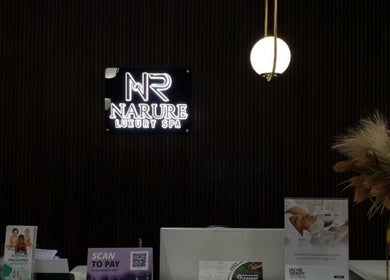 Reception of Narure Luxe Aesthetics in Emalahleni, Mpumalanga, ZA with illuminated signage and elegant decor.