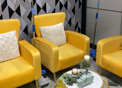 Chic yellow lounge at Narure Luxe Aesthetics in Emalahleni, Mpumalanga, ZA, exuding warmth and comfort.