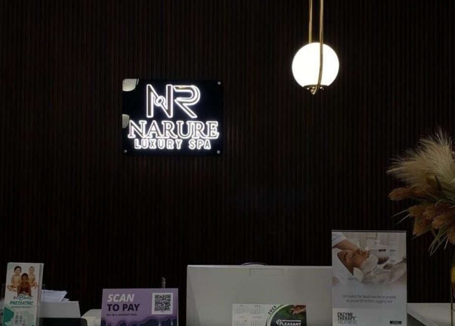 Elegant reception of Narure Luxe Aesthetics in Emalahleni, Mpumalanga, ZA, featuring illuminated signage and decor.