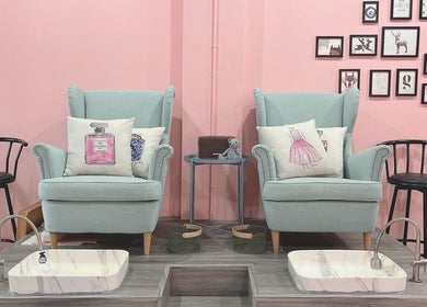 Pedicure chairs at Chateau de Nails BKK, Amphoe Bang Phli, Samut Prakan, TH, with pink walls and stylish decor.