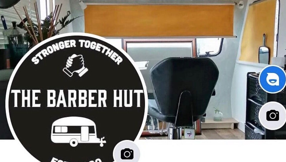 Interior view of The Barber Hut, Portrush, Northern Ireland with a stylish barber chair and modern decor.