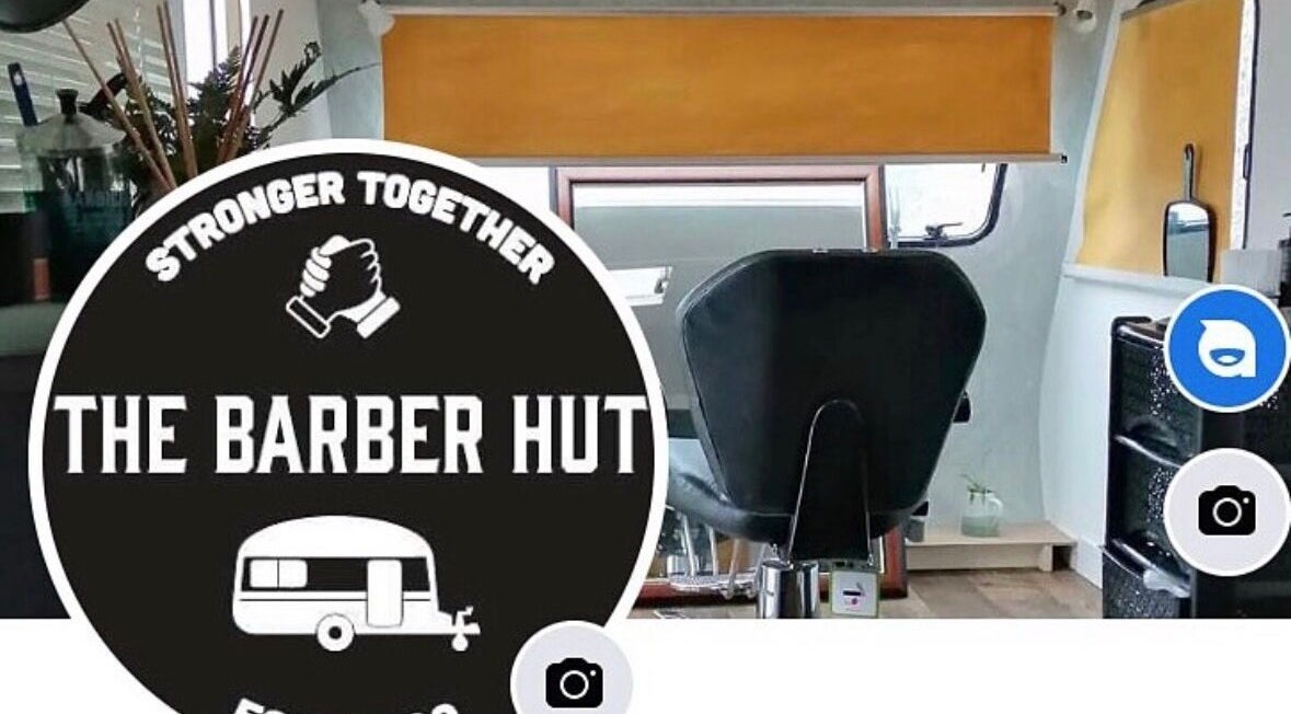 Interior view of The Barber Hut, Portrush, Northern Ireland with a stylish barber chair and modern decor.