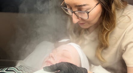 Facial treatment at D2 Hair Skin and Beauty, Worlingham, England; beautician applies mask amidst steam.