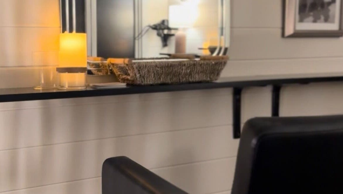 Warm candlelit corner at Femme Fatale Hair Portsmouth, England, GB featuring modern salon seating.