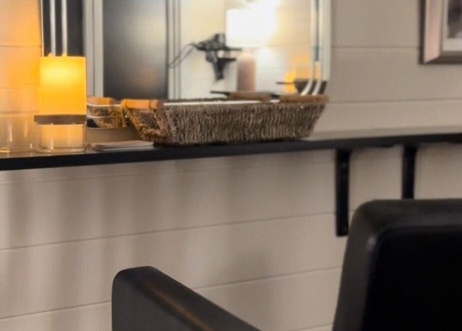 Warm candlelit corner at Femme Fatale Hair Portsmouth, England, GB featuring modern salon seating.