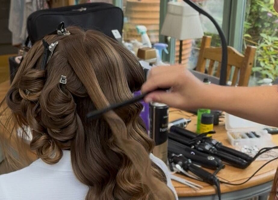 A stylist curling hair in Femme Fatale Hair Portsmouth, Portsmouth, England, GB.