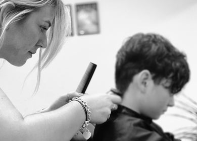 Stylist at Lauren Pomphrey Hairdressing in Andover, England, GB, expertly cutting client's hair.