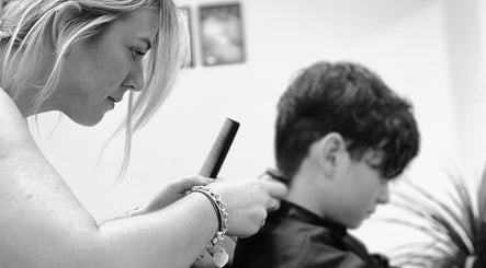 Stylist at Lauren Pomphrey Hairdressing in Andover, England, GB, expertly cutting client's hair.