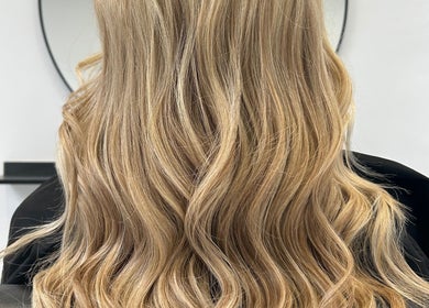 Blonde wavy hairstyle at Lauren Pomphrey Hairdressing, Andover, England, GB.