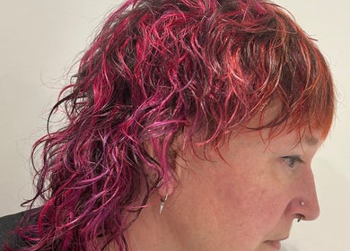Bright red and pink mullet hairstyle at Lauren Pomphrey Hairdressing in Andover, England, GB.