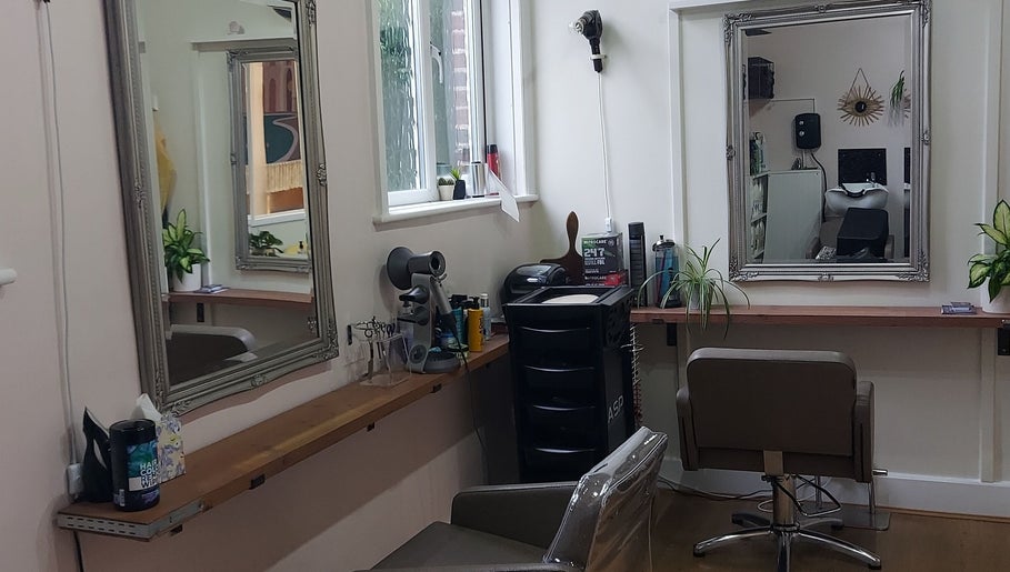 Modern styling station at Sabrina Kennyford Hairdressing, Wootton Bridge, England with mirrors and salon chairs.