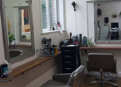 Modern styling station at Sabrina Kennyford Hairdressing, Wootton Bridge, England with mirrors and salon chairs.