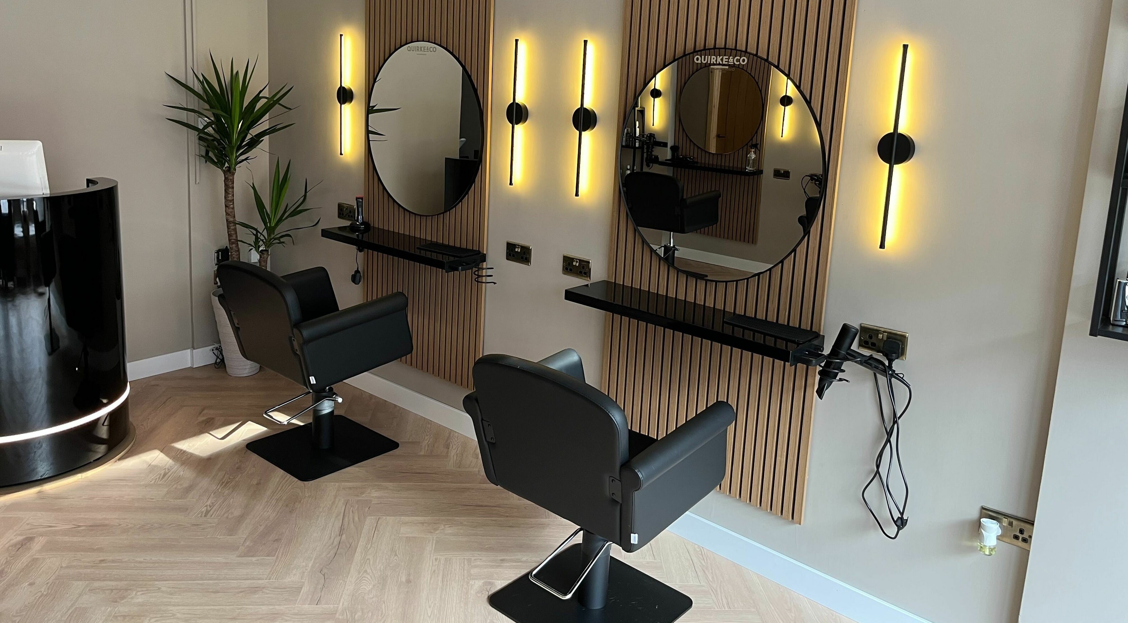 Modern salon chairs and mirrors at Quirke & Co Hairdressers, Pontypridd, Wales, GB, reflecting chic elegance.