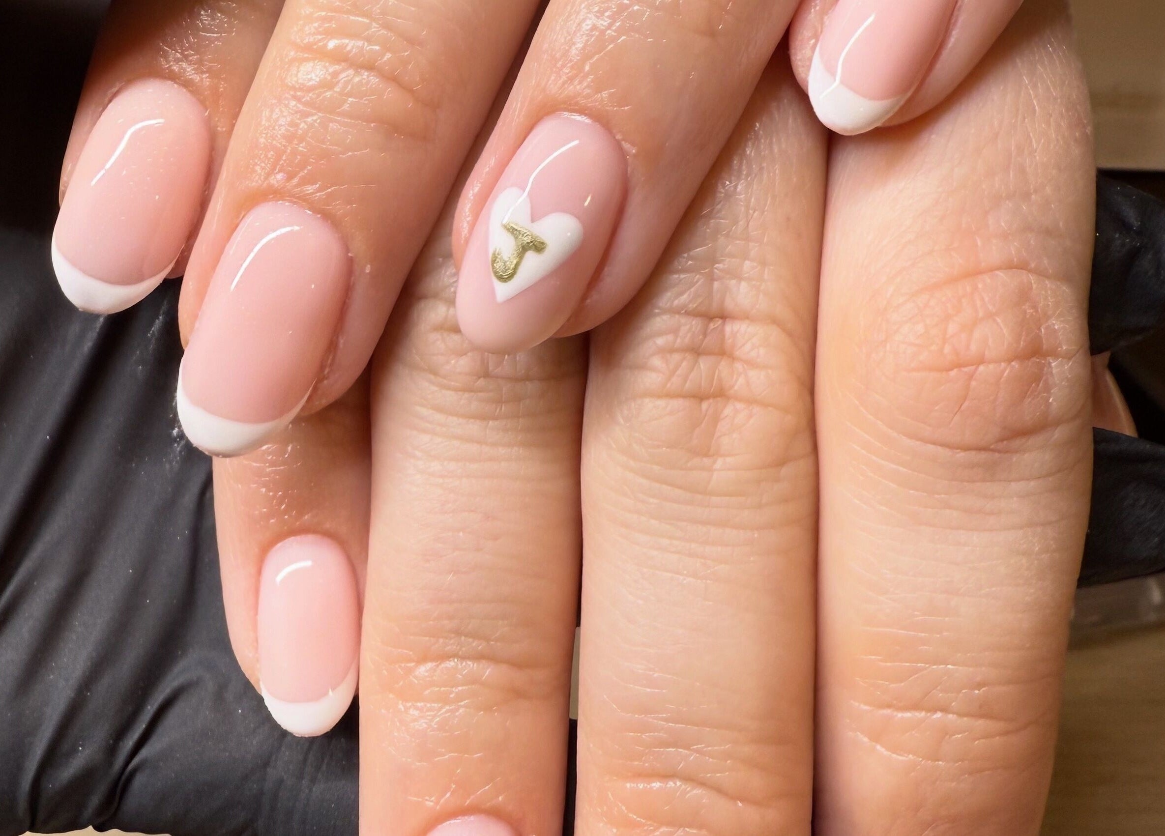 Elegant French manicure with heart detail at Bonnie Beauty, Betley, England, GB.